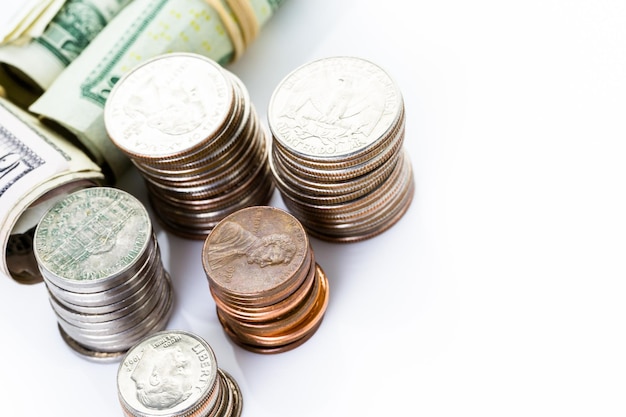 American bills and coins on a white backgreound.