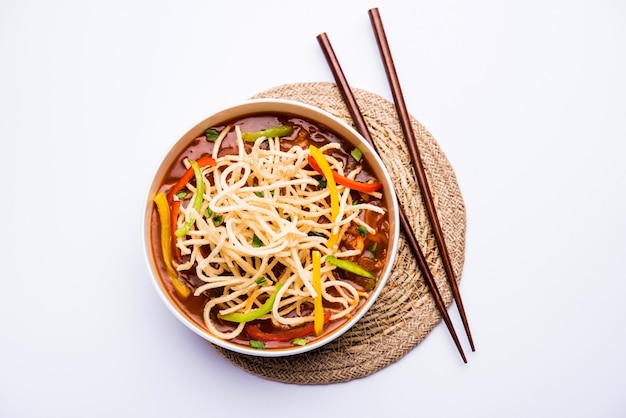 American chop suey or chopsuey is a popular indochinese food. served in a bowl with chop sticks. selective focus