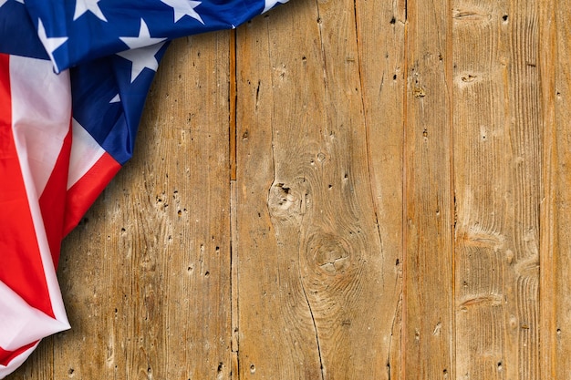 American Flag for the America's 4th of July Celebration over a white wooden rustic background to mark America's Independence Day. Image shot from top view.