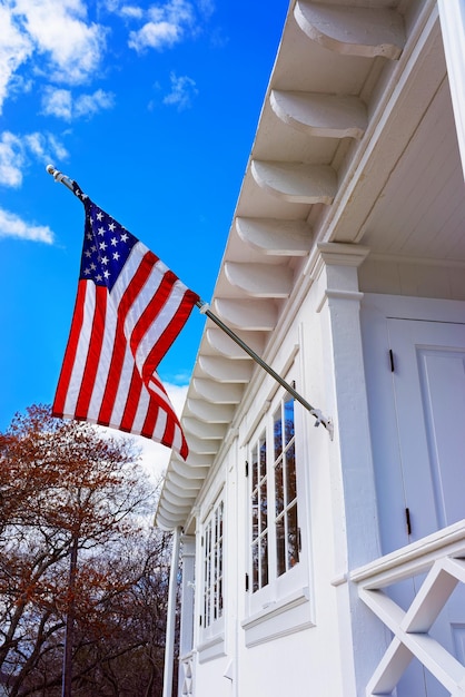 American flag on Sandy Hook Light house museum. It is the oldest lighthouse still working now. Sandy Hook is located in Highlands in Monmouth County of New Jersey, the USA. Selective focus