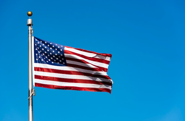 American Flag waving against blue Sky, USA Flag waving 