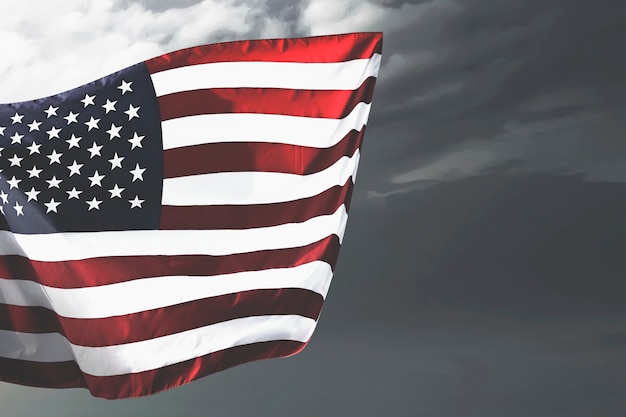 American flag waving in the air with a dramatic sky