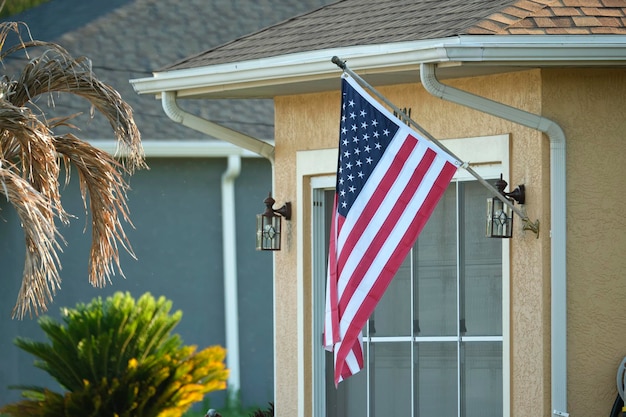 American flag waving on the corner of private residential house symbol of patriotism