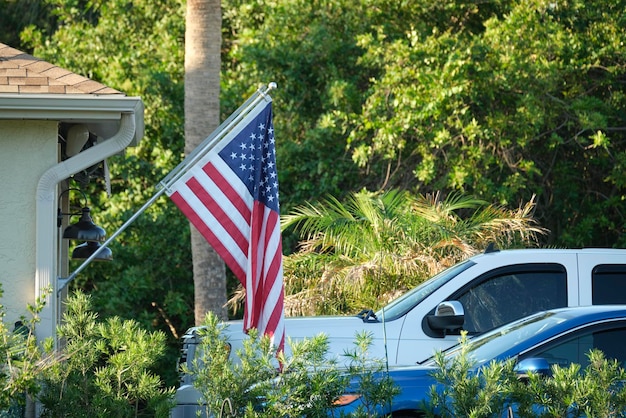 American flag waving on the corner of private residential house symbol of patriotism