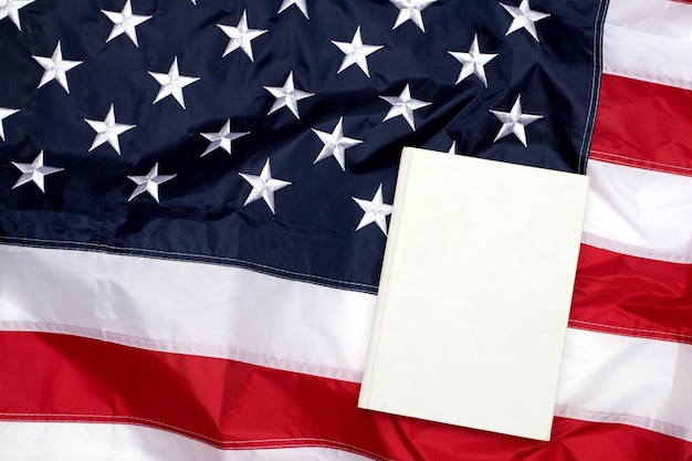 American Flag with white blank book. Flag of the USA. Memorial Day. Independence Day 4th of July.