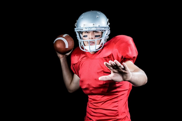 American football player throwing ball