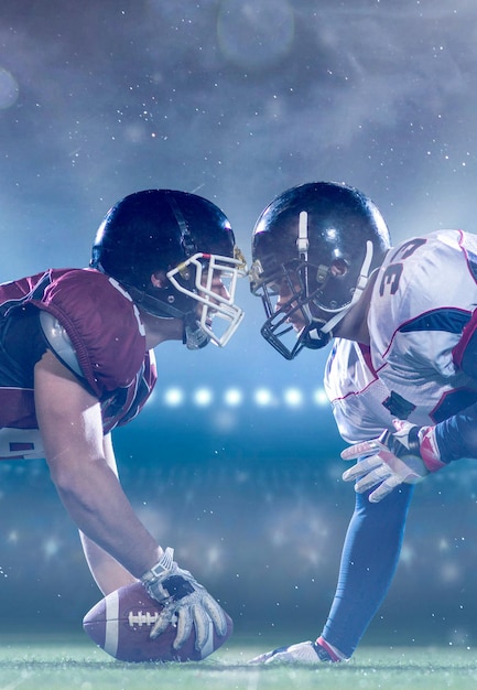 american football players are ready to start a match on modern field at night