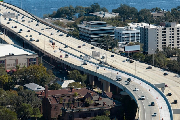 American freeway intersection with fast driving cars and trucks View from above of USA transportation infrastructure