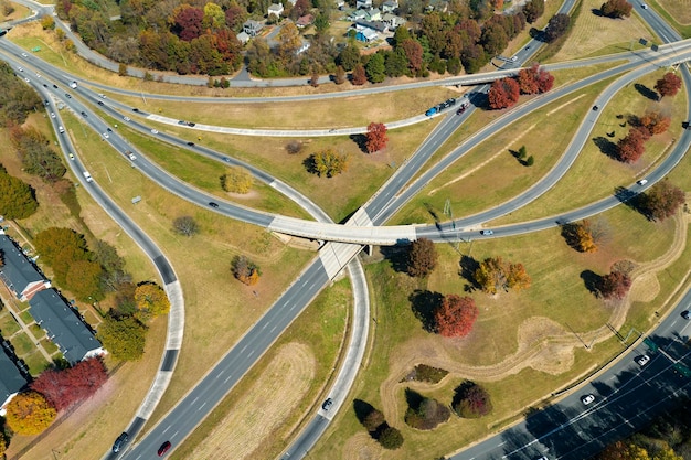 American freeway intersection with fast driving cars and trucks View from above of USA transportation infrastructure