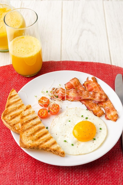 American style breakfast with orange juice Eggs cherry tomatoes sprouts pepper