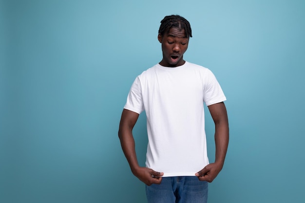 American young man with dreadlocks is wearing a white tshirt for printing information on it