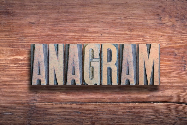 Anagram word combined on vintage varnished wooden surface