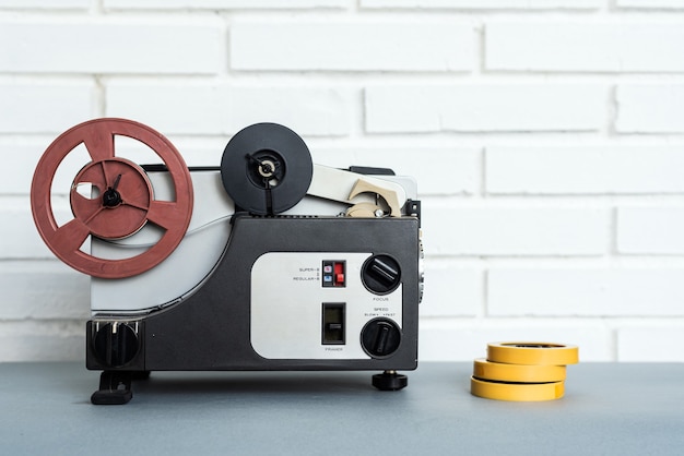 Analog audio device and tapes placed on table near white brick wall at home