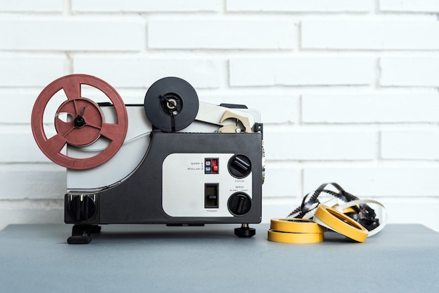 Analog audio device and tapes placed on table near white brick wall at home