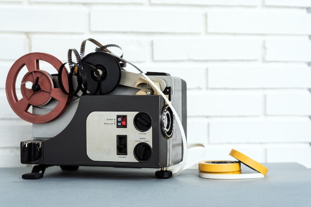 Analog audio device and tapes placed on table near white brick wall at home