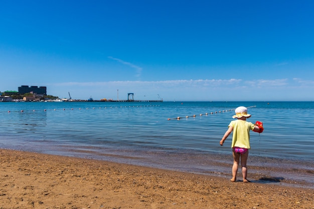 anapa. krasnodar region   may 14. 2021 a child plays on the black sea coast 