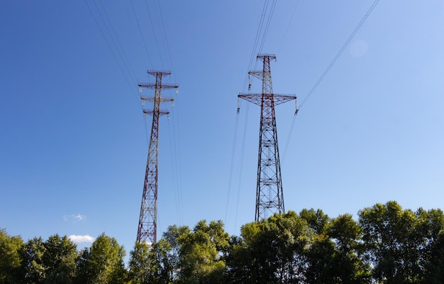 Anchor highvoltage poles on the background of the blue sky