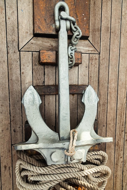 The anchor lies on the wooden deck of the ship