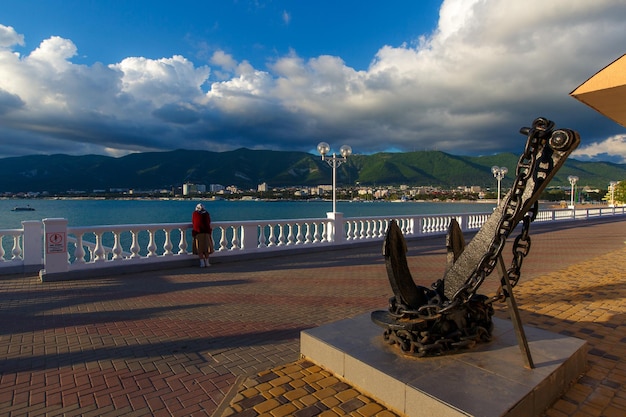 Anchor  a monument on the Gelendzhik embankment at sunset In the background the Caucasus mountain