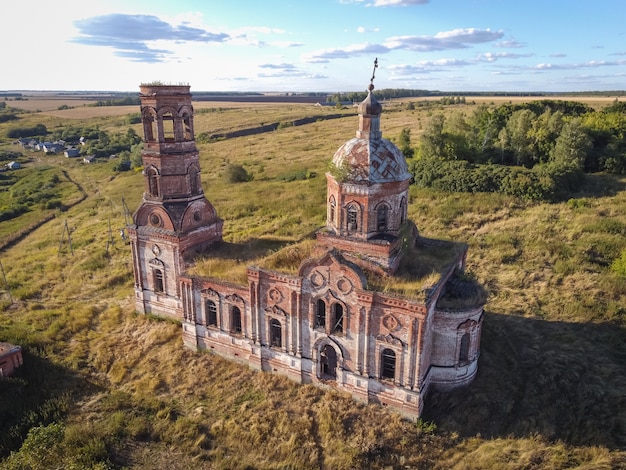 Ancient abandoned and ruined church illuminated by the setting sun.