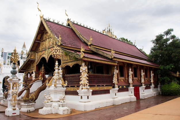 Ancient architecture ubosot church and antique building for thai people travelers travel visit and respect praying blessing holy worship in Wat Ming Mueang or Ming Muang temple in Chiang Rai Thailand