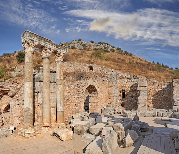 Ancient city ruins and pillars of Ephesus in Turkey in the day Traveling abroad overseas for holiday vacation tourism Excavated remains of historical stone building in Turkish history culture