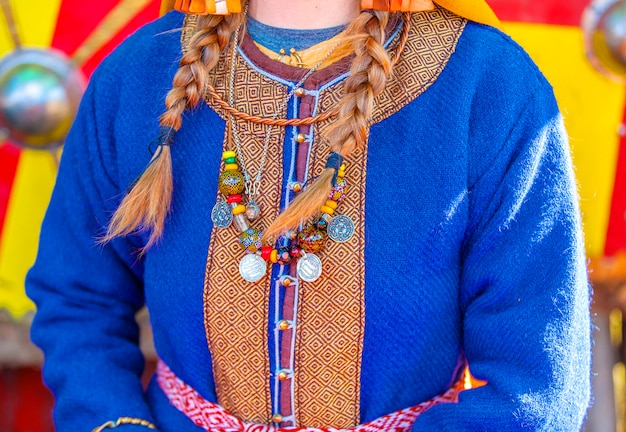 Ancient coins and ornaments on the clothes of the medieval female.