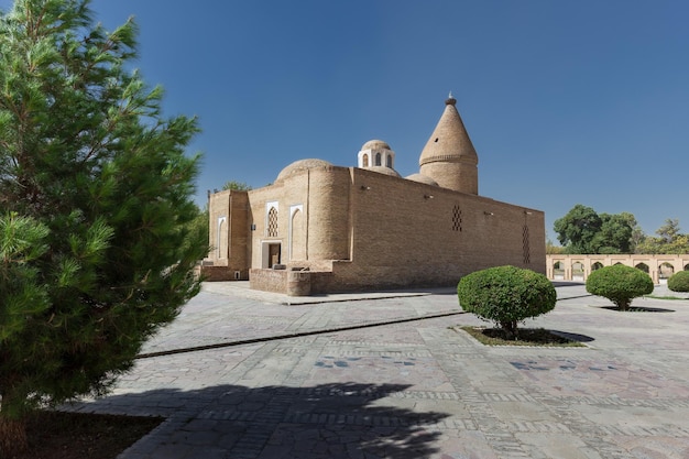 Ancient heritage ChashmaAyub Mausoleum with conical dome surrounded by trees Bukhara Uzbekistan