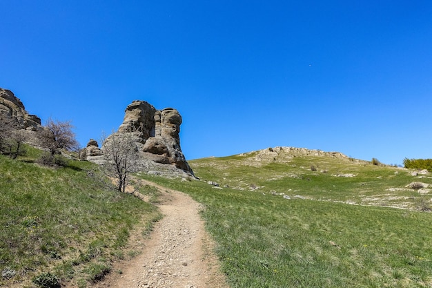 Ancient limestone high mountains of rounded shape in the air haze The Valley of Ghosts Demerji Crimea