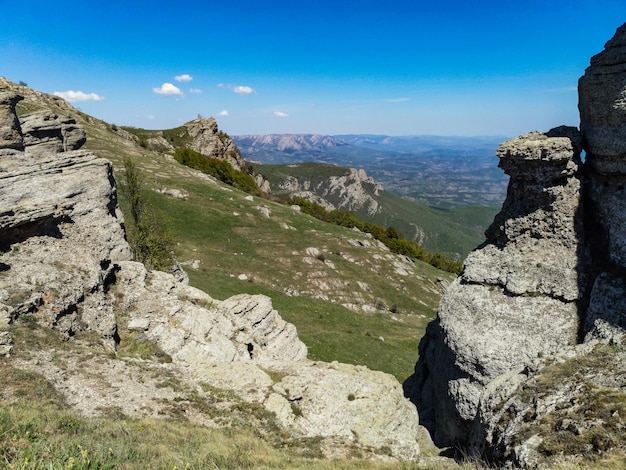 Ancient limestone high mountains of rounded shape in the air haze The Valley of Ghosts Demerji Crimea