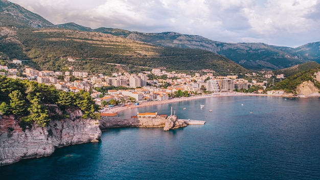 The ancient Mediterranean resort town of Petrovac in Montenegro, aerial view on a sunny day.