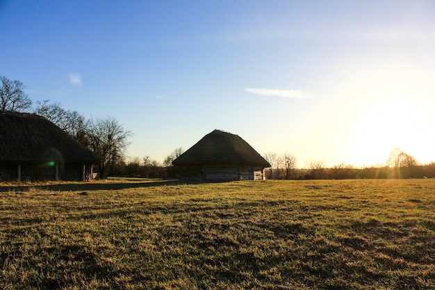 Ancient peasant Ukrainian house with a thatched roof in the old village of national architecture, Ukraine. National Museum Pirogovo in the outdoors near Kiev