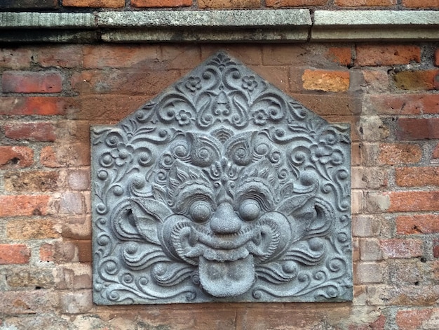 Ancient relief kalamakara on the terracotta wall of the Mataram Kotagede mosque Yogyakarta Indonesia