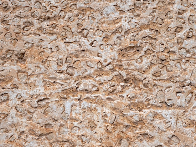 Ancient rough beige stone wall grunge texture