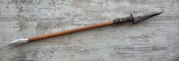 ancient spear on white wooden background