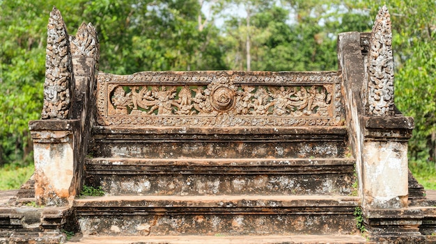 Photo ancient stone steps with intricate carvings and green foliage