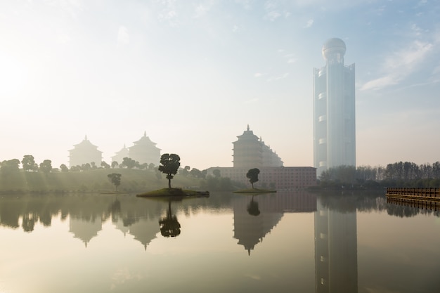 Ancient Tallinn and modern architecture, in the early morning, there is mist on the water surface, China