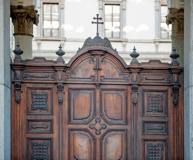 Ancient wooden carved door with crucifix