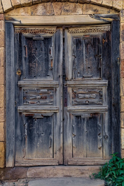 Ancient wooden doors in the ruins of the abandoned village of Gamsutl Dagestan