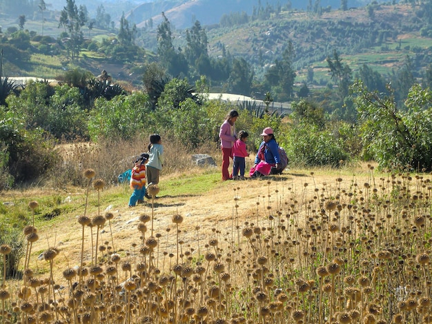 An Andean family walking through the countryside