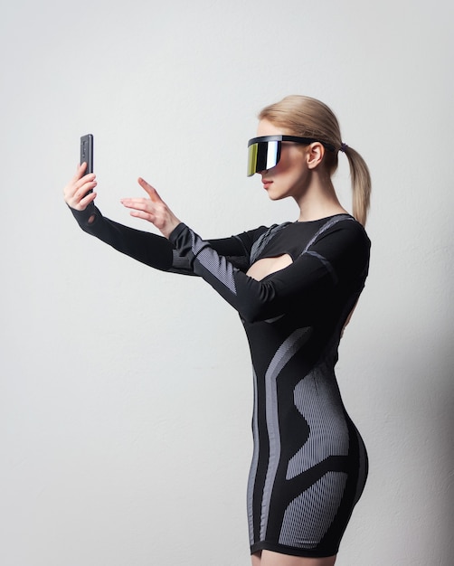 Android female in VR glasses and mobile phone on white background.