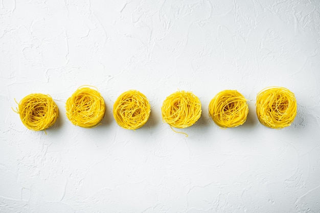 Angel hair pasta set, on white stone surface