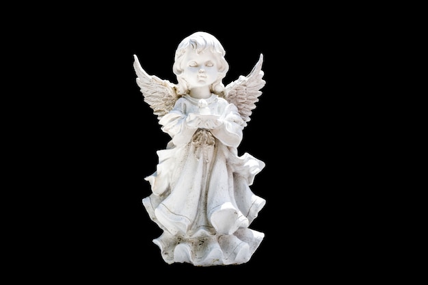 Angel statuette isolated on a black background. High quality photo