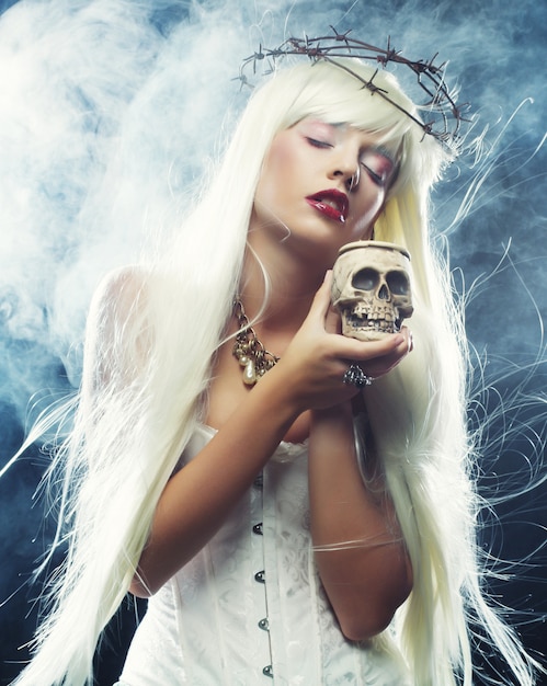 Angelic long hair woman with skull