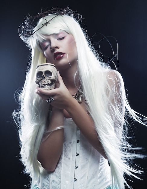 Angelic long hair woman with skull