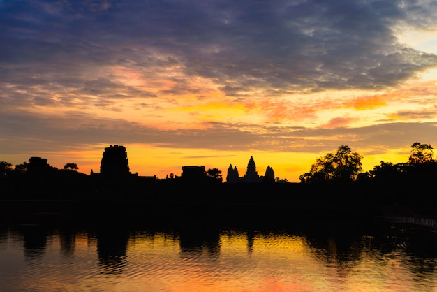 Angkor Wat dramatic sky at dawn main facade silhouette reflection on water pond