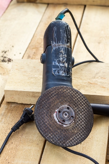 Angle grinder on table, construction concept