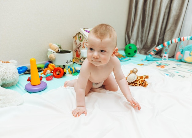 Above angle shot of adorable Baby boy lying on child friendly floor puzzle mats looking up