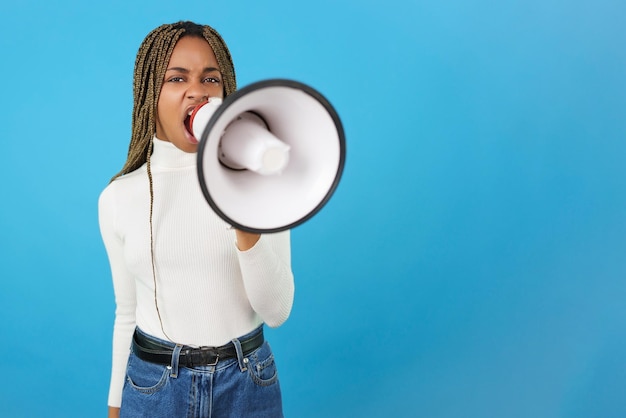 Angry african woman protesting while using a loudspeaker