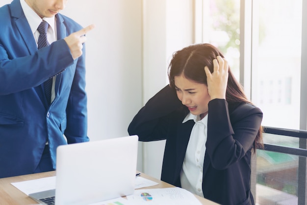 Angry boss point fingers blaming to Asian business woman employee 